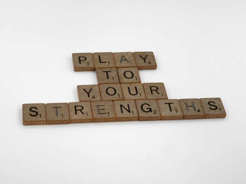 Close-Up Shot of Scrabble Tiles on White Surface